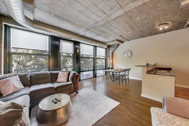 a living room with furniture and a floor to ceiling window