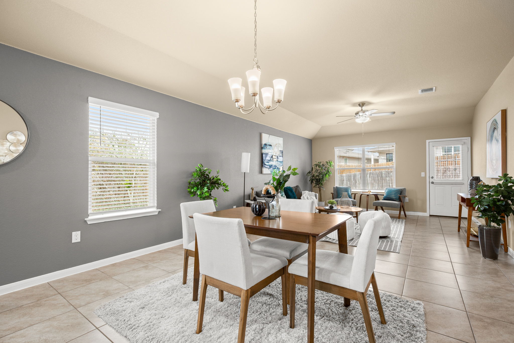 3100 Crystal Bend Drive Pflugerville, TX 78660 - Photo 12 of 32 Dining room with ceiling fan, healthy amount of natural light, light tile patterned flooring, and a chandelier