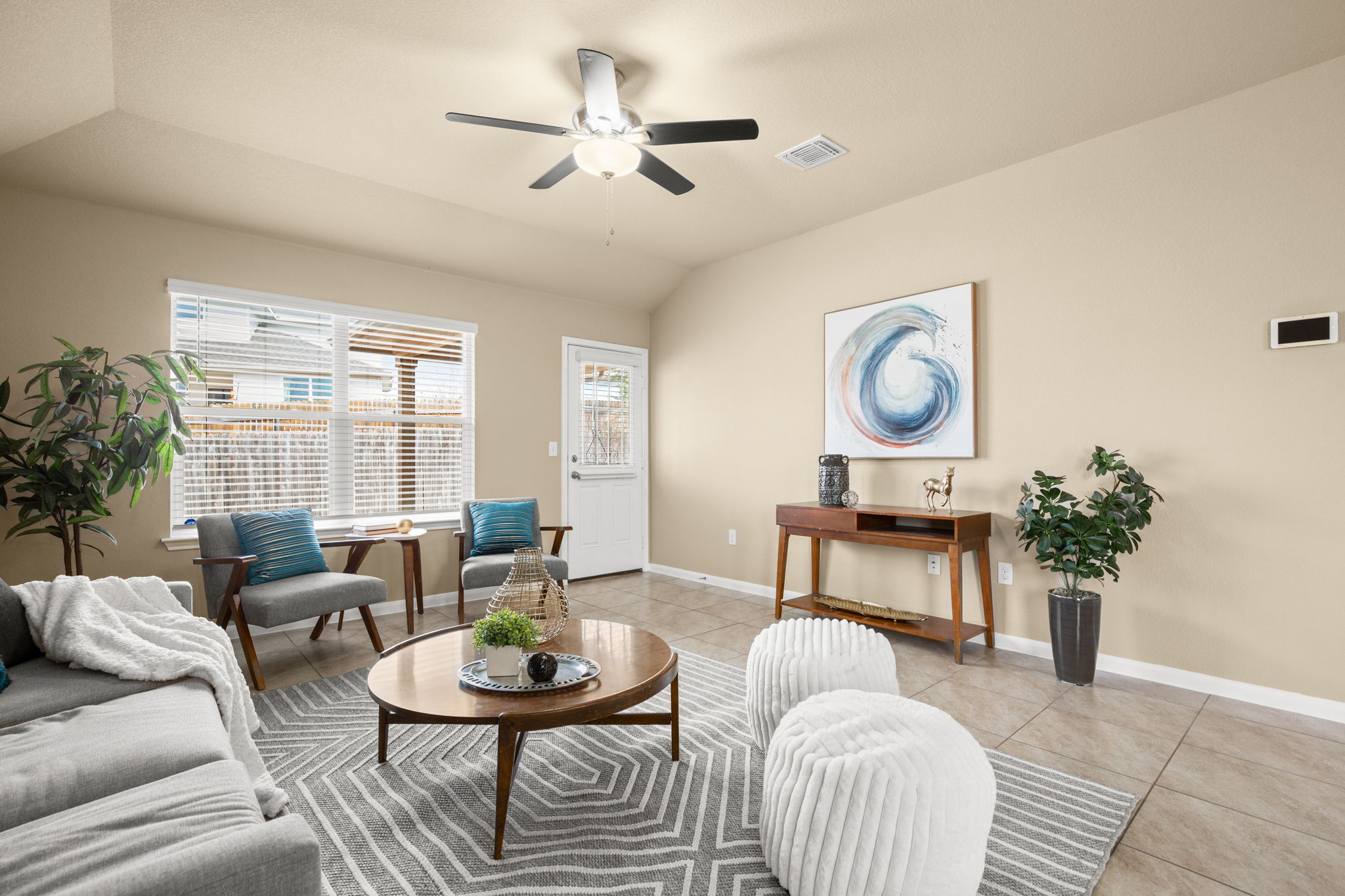 3100 Crystal Bend Drive Pflugerville, TX 78660 - Photo 14 of 32 Living area with light tile patterned flooring, vaulted ceiling, and a ceiling fan