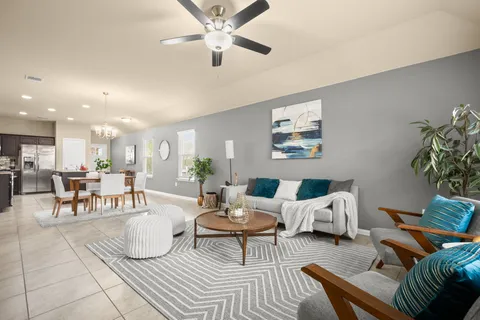 a living room with furniture and a view of kitchen