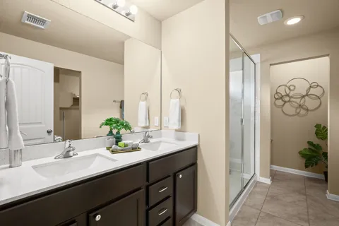 a bathroom with a double vanity sink and a mirror