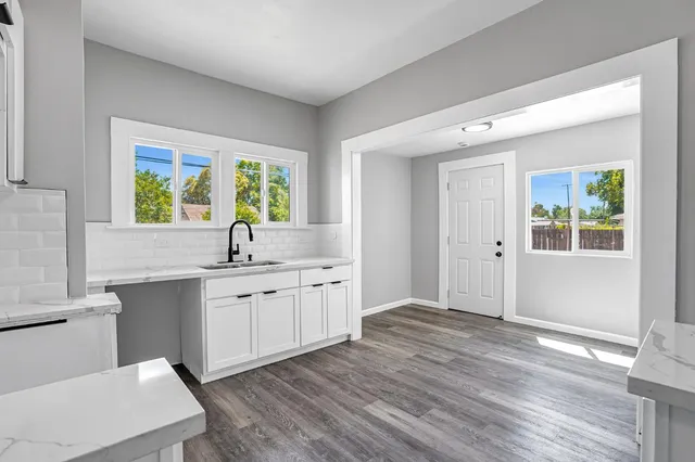 a kitchen with sink cabinets and wooden floor