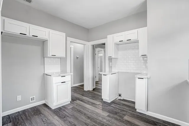 a view of walk in closet with wooden floor