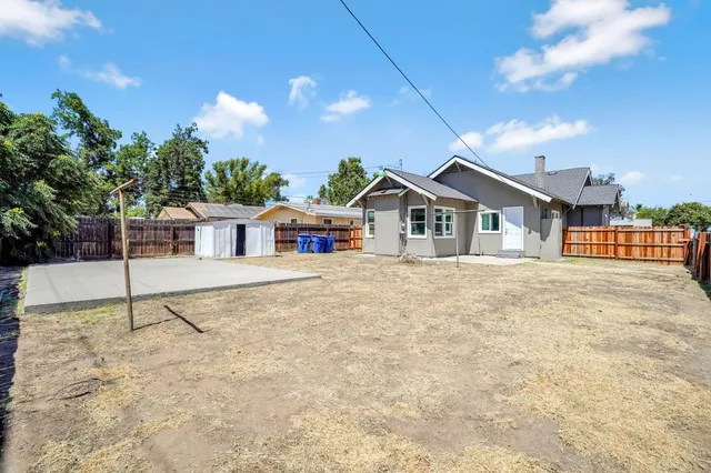 a view of white house with a yard