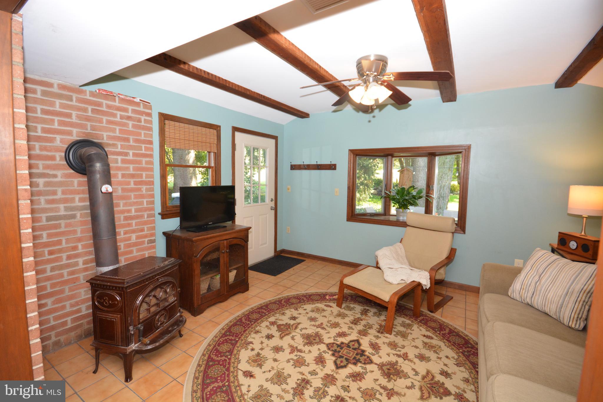 19 Wolf Road Akron, PA 17501 - Photo 3 of 42 Sitting Room w/Wood Burning Stove & Door to Patio