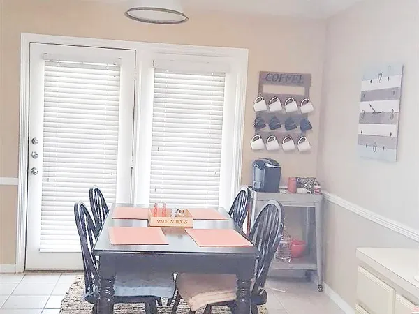 a view of a dining room with furniture and window