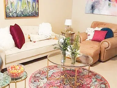 a living room with a bed and a painting on the wall