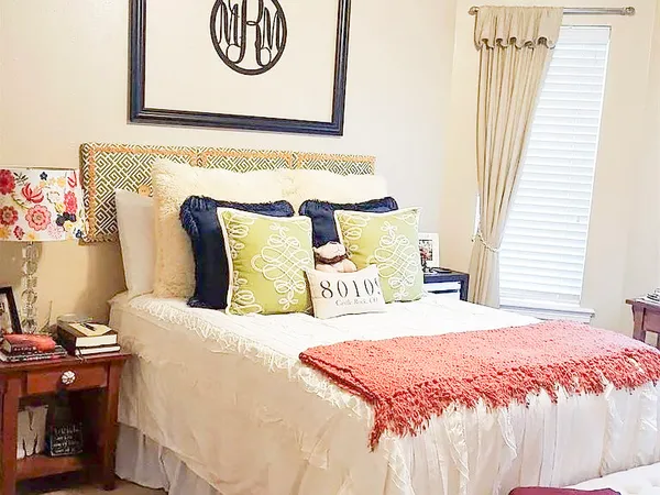 a bedroom with a bed and a window