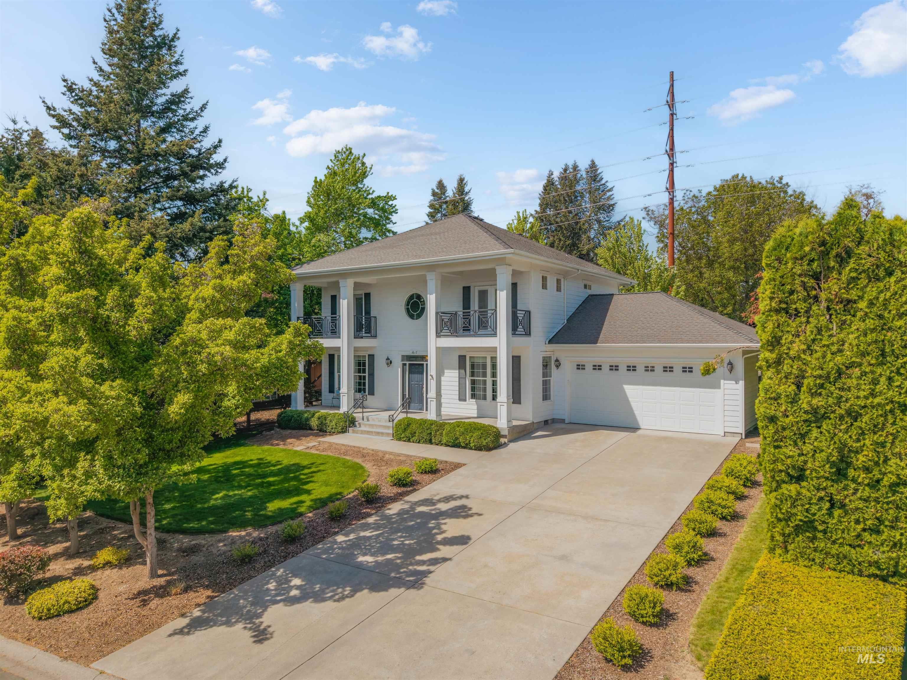1617 Pine Cone Road Moscow, ID 83843 - Photo 1 of 44 Two-story Colonial-style residence featuring a prominent front entrance with dual columns and a second-story balcony