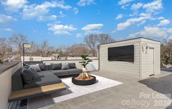 a view of a terrace with couches and a fire pit