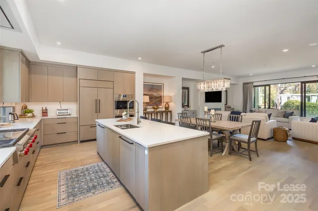 a open kitchen with stainless steel appliances kitchen island granite countertop a sink and cabinets