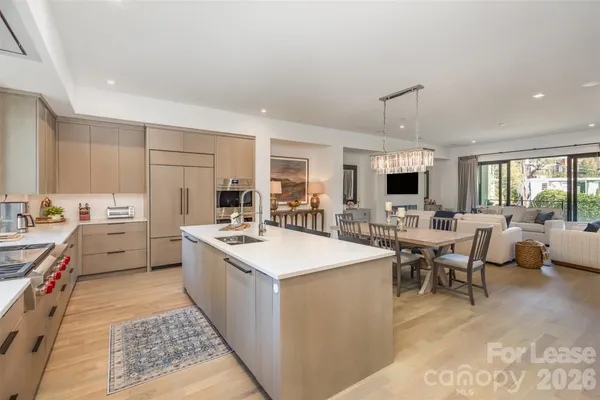 a open kitchen with stainless steel appliances kitchen island granite countertop a sink and cabinets