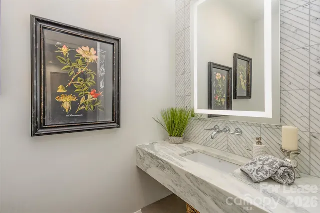 a bathroom with a tub sink and mirror