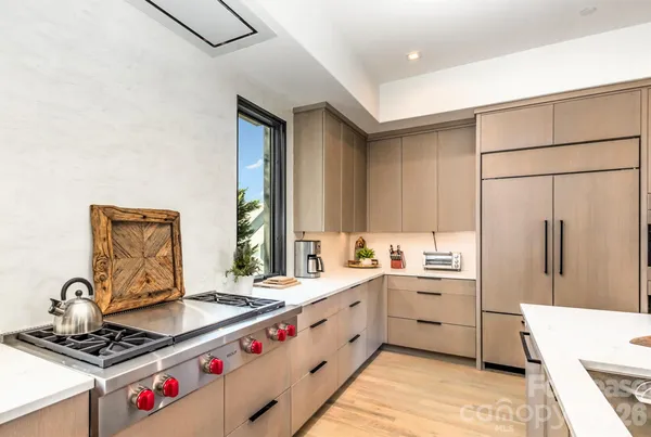 a kitchen with stainless steel appliances a sink stove and refrigerator