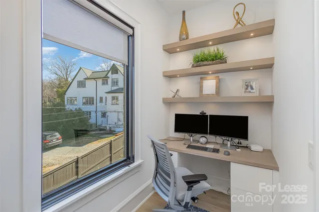 a spacious bedroom with a bed couch and a large window