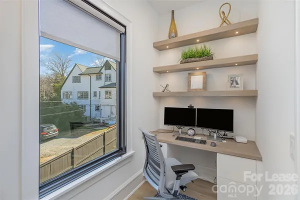 a spacious bedroom with a bed couch and a large window
