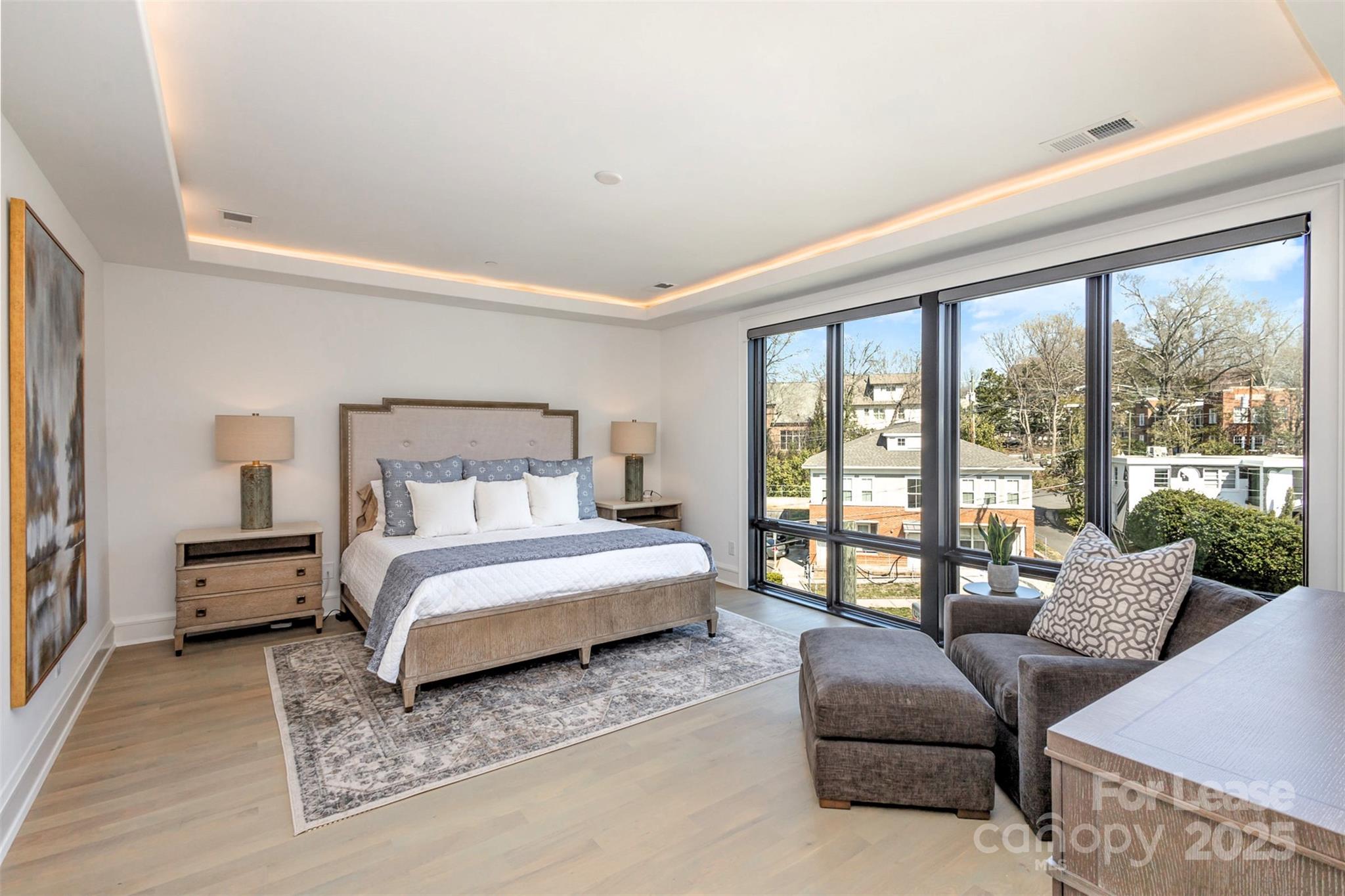 616 Queens Road Charlotte, NC 28204 - Photo 22 of 36 a spacious bedroom with a bed couch and a large window