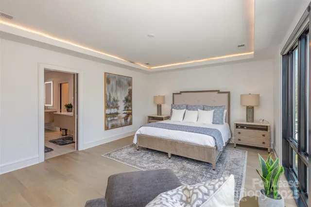 a bedroom with furniture and a flat screen tv