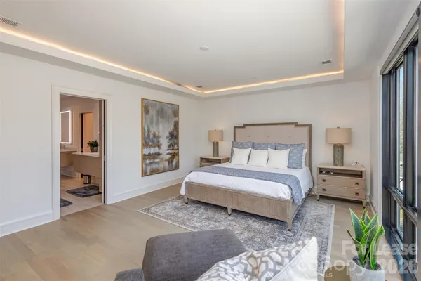 a bedroom with furniture and a flat screen tv