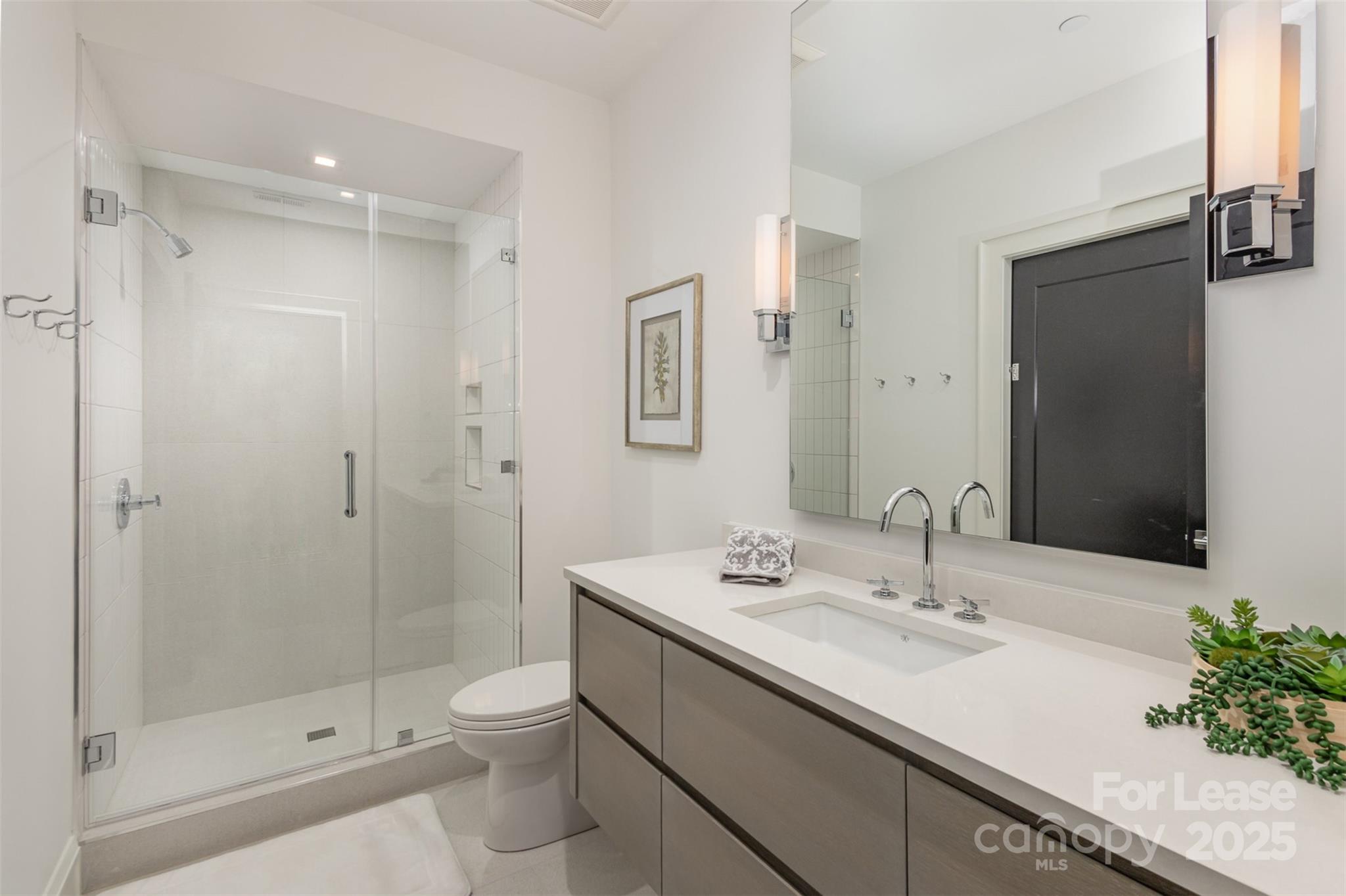 616 Queens Road Charlotte, NC 28204 - Photo 30 of 36 a bathroom with a sink a toilet and shower