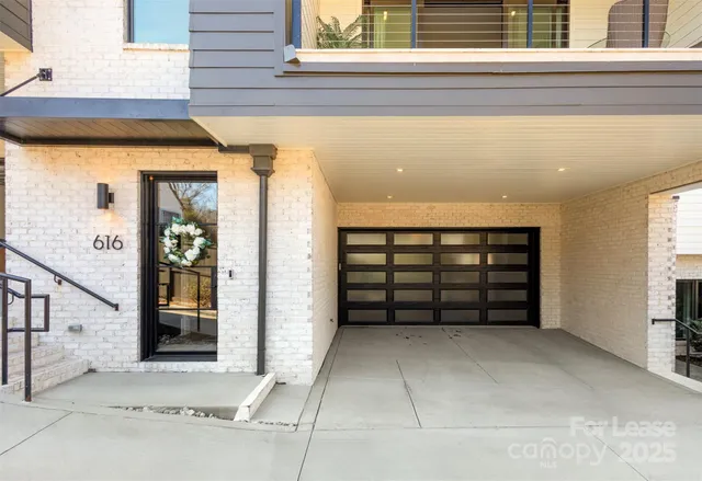 an empty room with a fireplace and windows