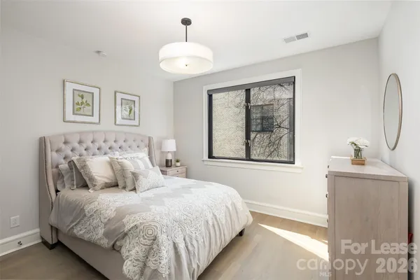 a bedroom with a large bed and a window