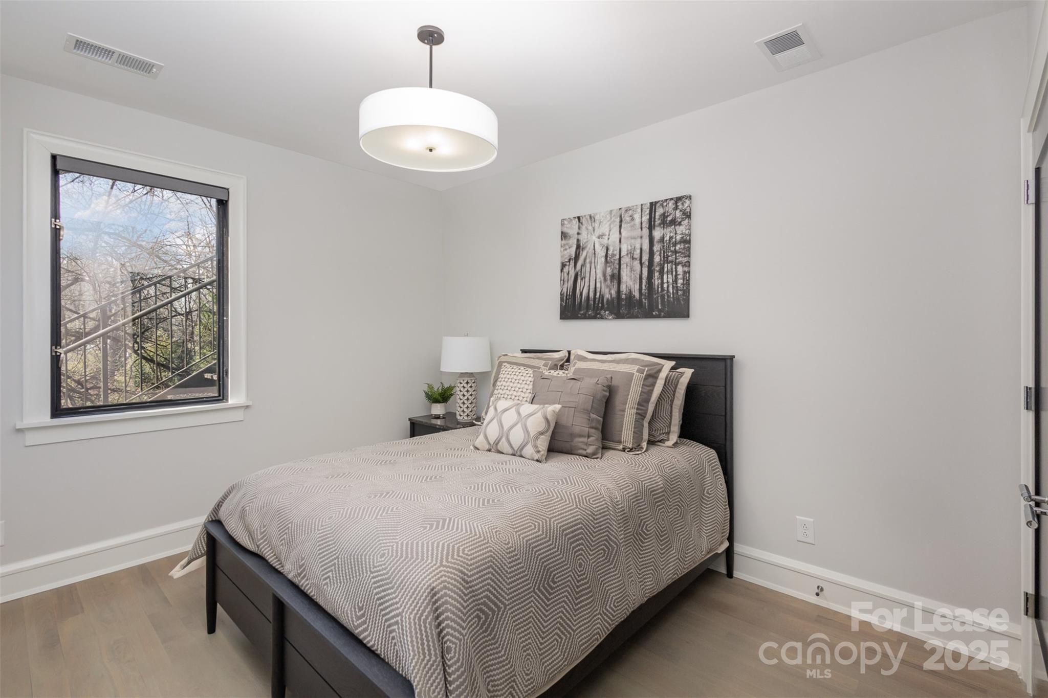 616 Queens Road Charlotte, NC 28204 - Photo 32 of 36 a bedroom with a large bed and a window