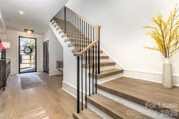 a view of entryway and hall with wooden floor