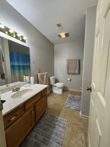 a spacious bathroom with a double vanity sink and a mirror