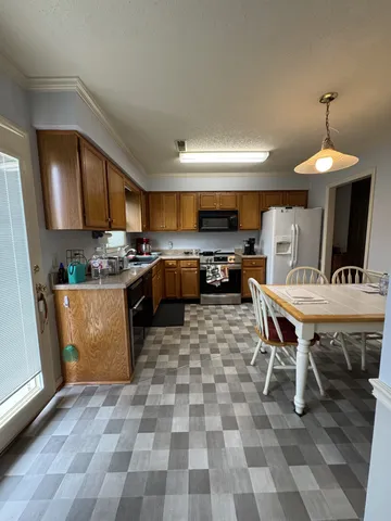 a kitchen with a sink a counter and appliances