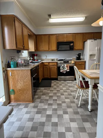 a kitchen with stainless steel appliances a stove a sink and a refrigerator