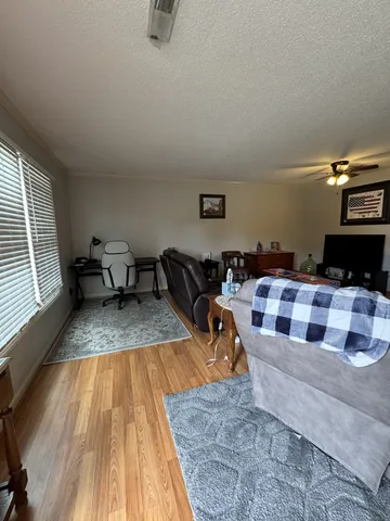 a living room with furniture and a wooden floor