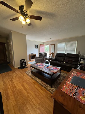 a living room with furniture and a chandelier