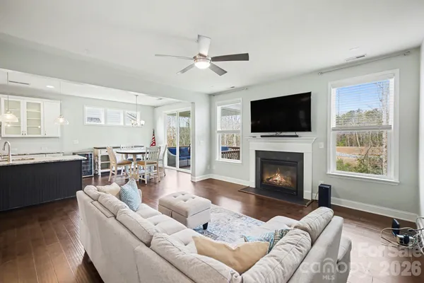 a living room with furniture fireplace and flat screen tv