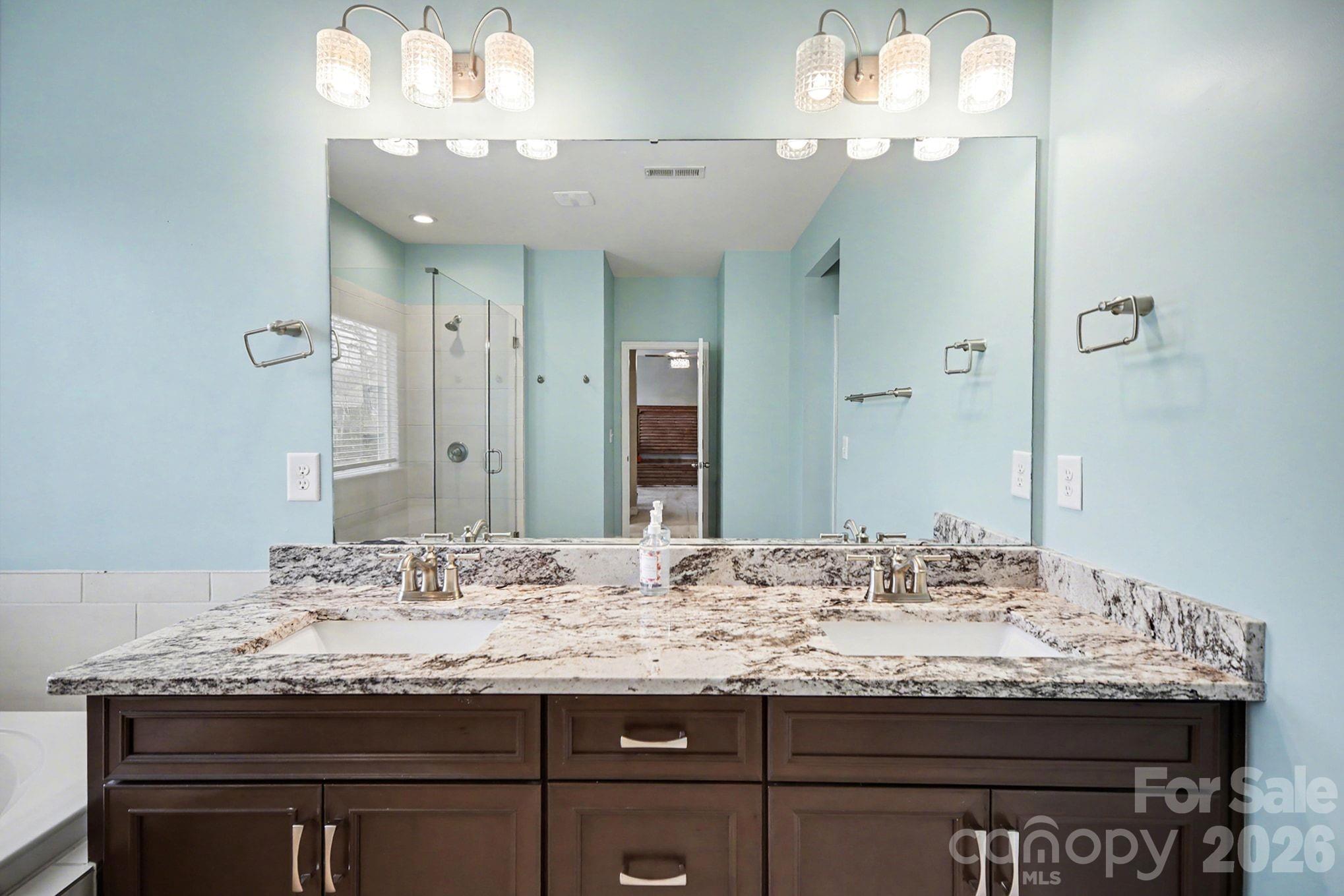 7200 Irongate Drive Lancaster, SC 29720 - Photo 15 of 30 a bathroom with a granite countertop sink and a mirror