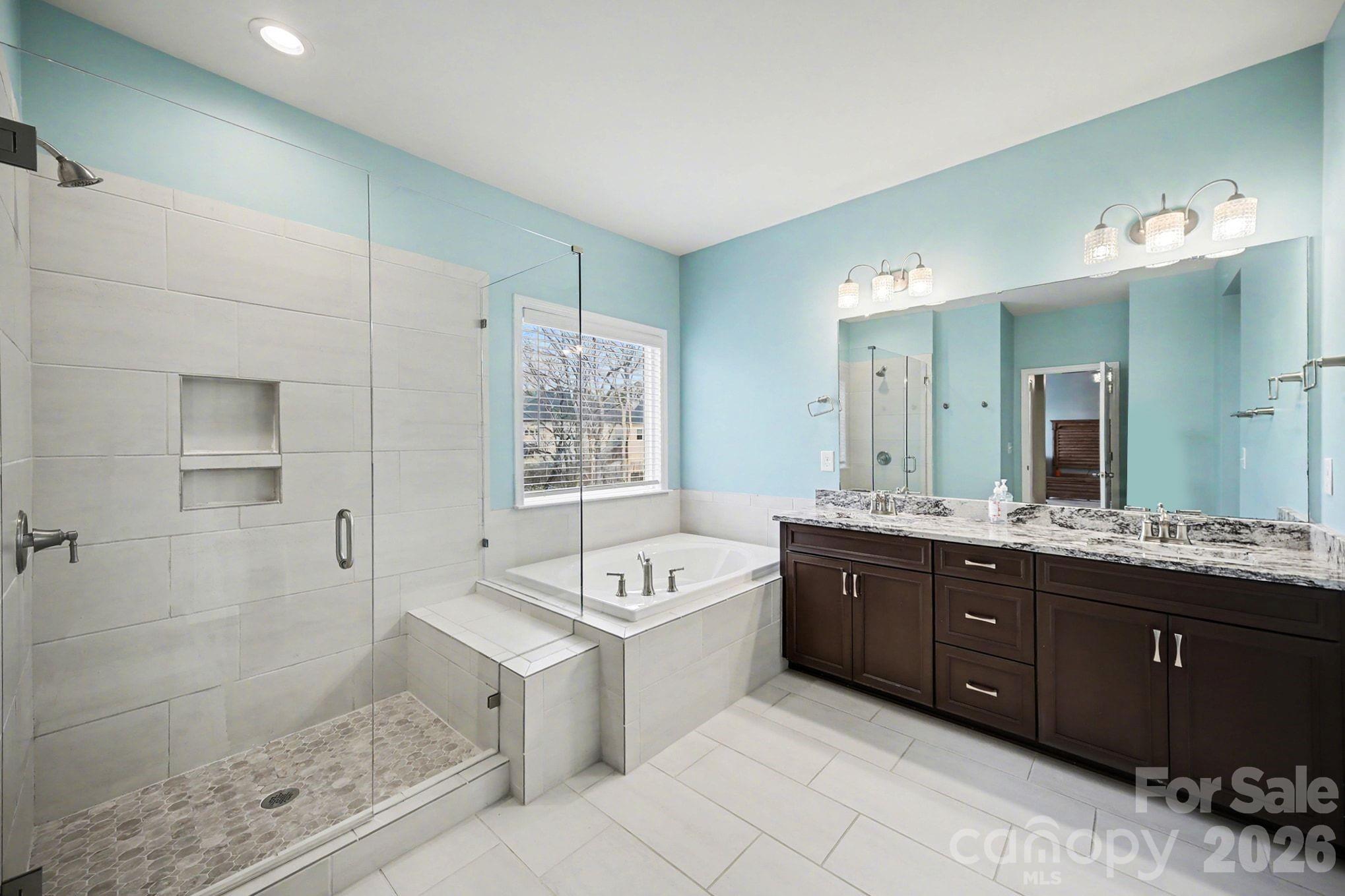 7200 Irongate Drive Lancaster, SC 29720 - Photo 16 of 30 a spacious bathroom with a tub sink shower and mirror