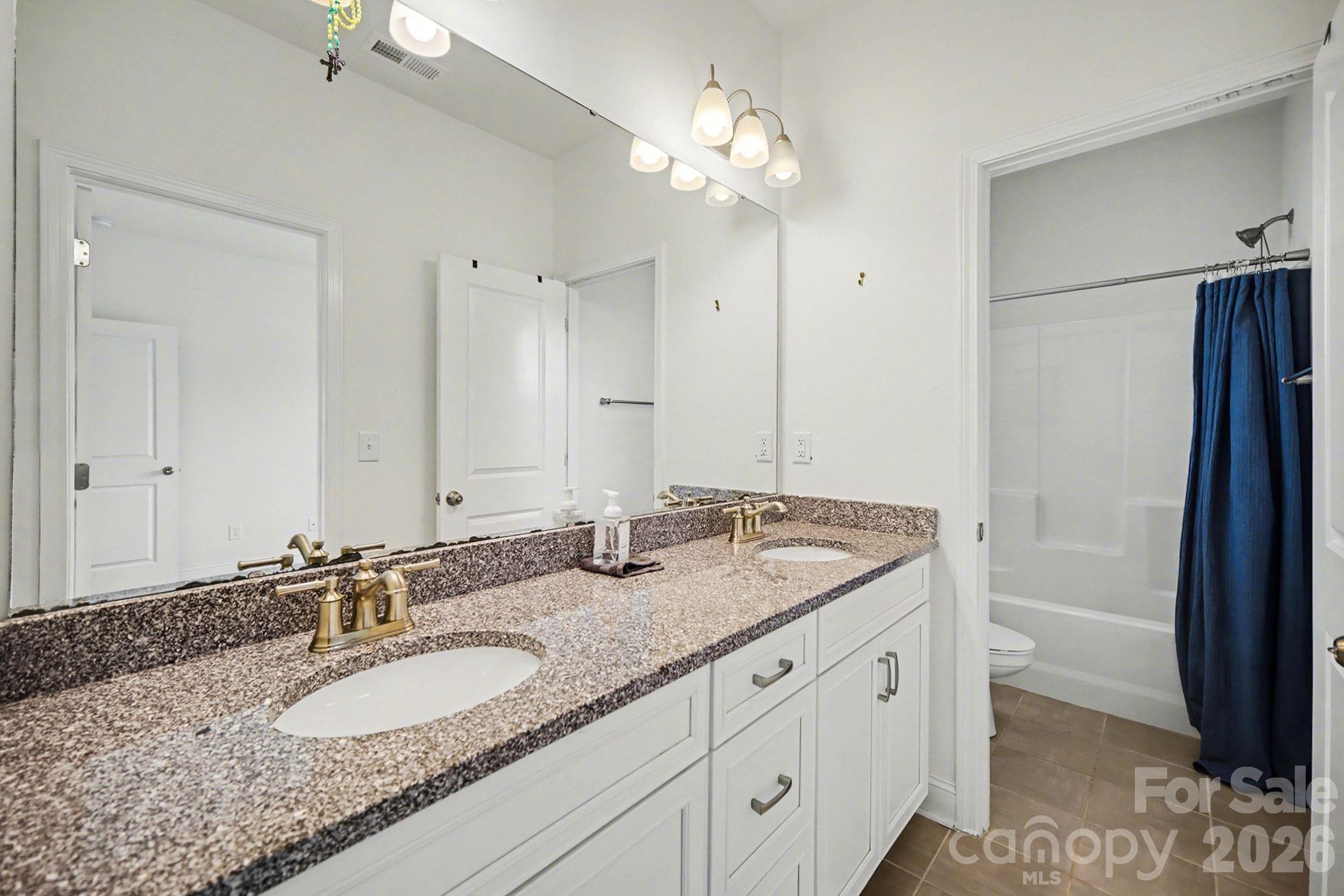 7200 Irongate Drive Lancaster, SC 29720 - Photo 19 of 30 a bathroom with a granite countertop double vanity sink and mirror