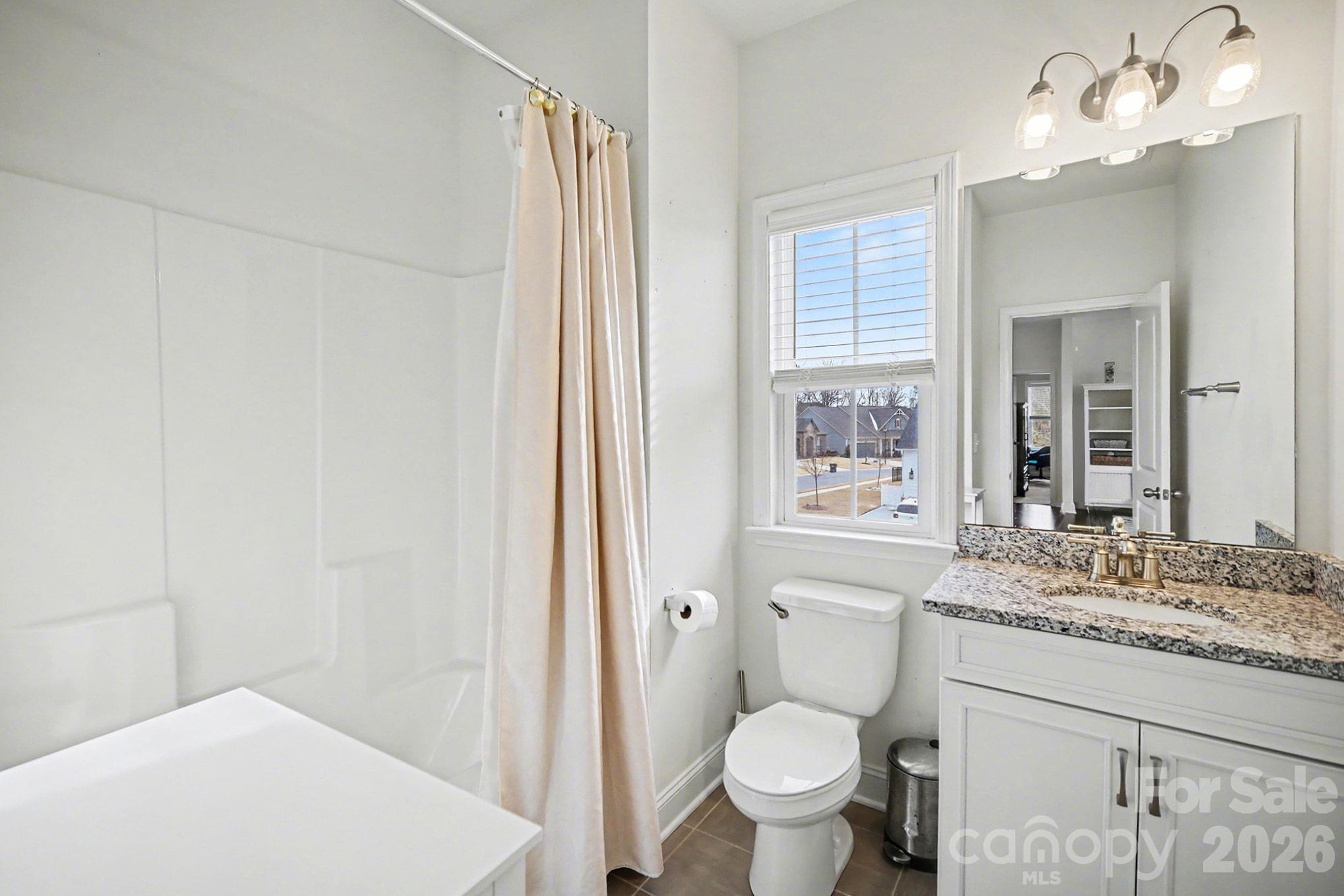 7200 Irongate Drive Lancaster, SC 29720 - Photo 22 of 30 a bathroom with a granite countertop sink toilet and shower