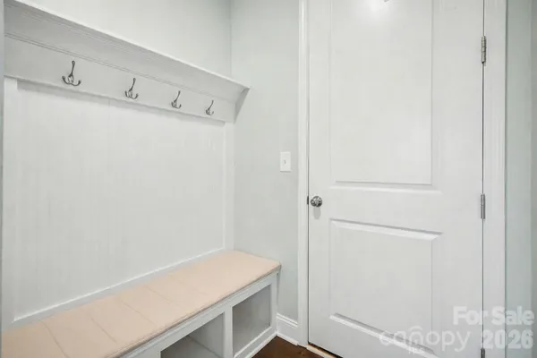 a bathroom with a granite countertop double vanity sink and mirror