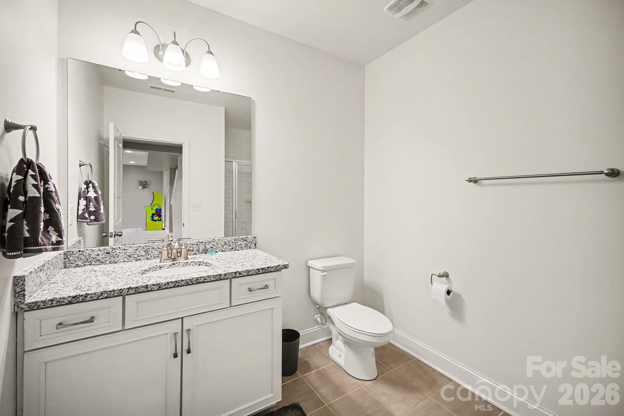 7200 Irongate Drive Lancaster, SC 29720 - Photo 26 of 30 a bathroom with a granite countertop sink vanity mirror and toilet