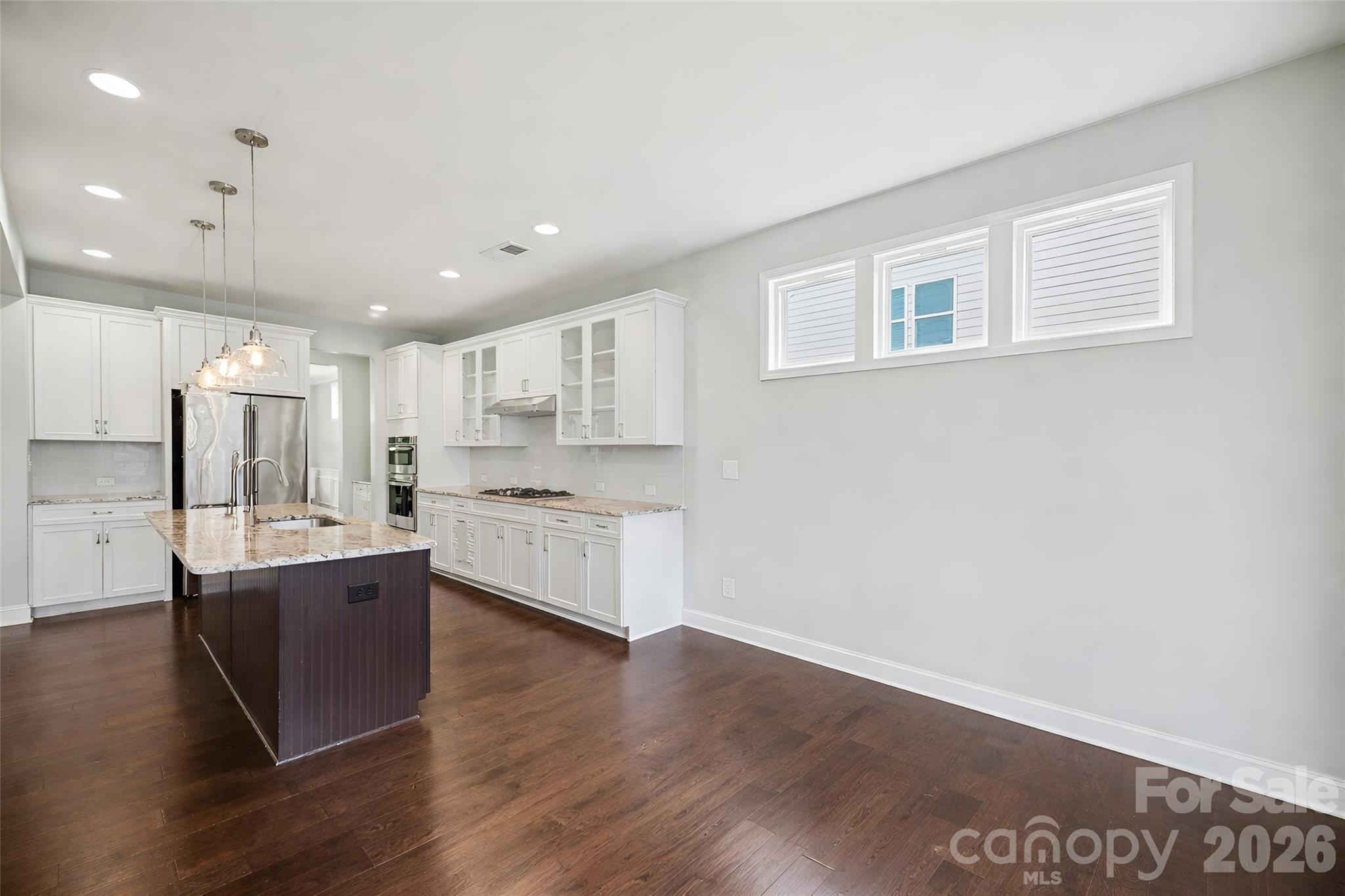 7200 Irongate Drive Lancaster, SC 29720 - Photo 6 of 30 a large kitchen with a center island wooden floor and stainless steel appliances