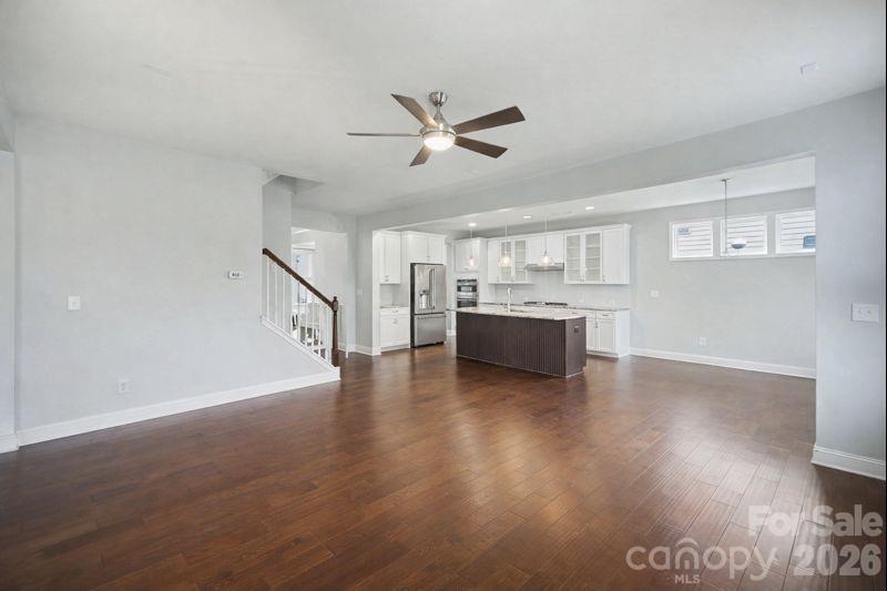 7200 Irongate Drive Lancaster, SC 29720 - Photo 8 of 30 a view of an empty room with a kitchen and wooden floor