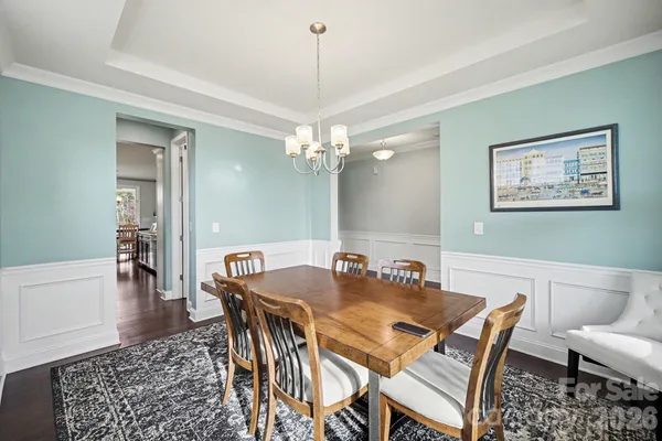a dining room with furniture and chandelier