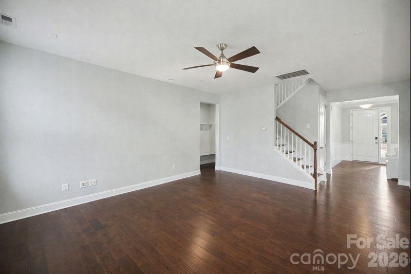 7200 Irongate Drive Lancaster, SC 29720 - Photo 9 of 30 a view of an empty room with wooden floor and a ceiling fan