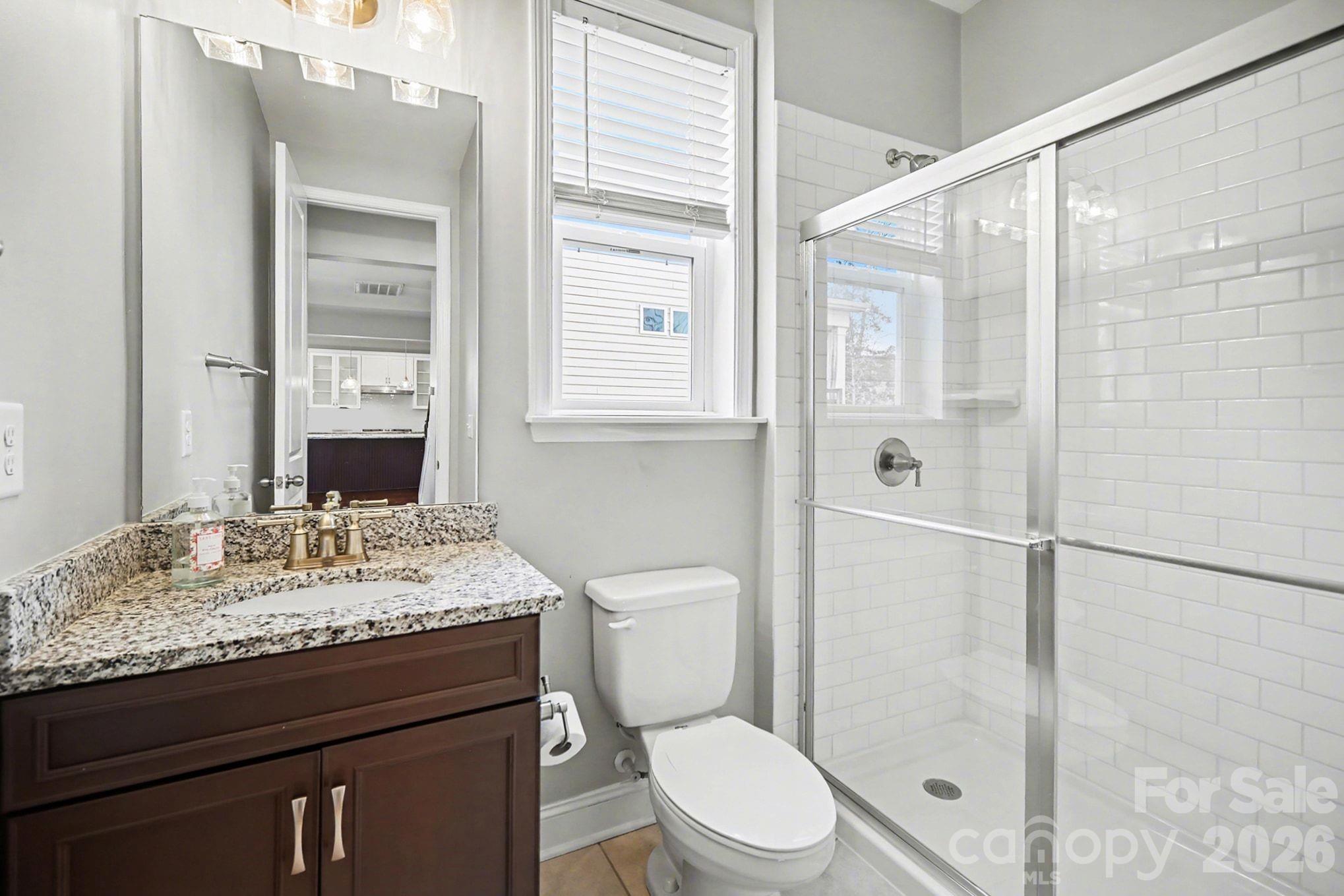 7200 Irongate Drive Lancaster, SC 29720 - Photo 10 of 30 a bathroom with a granite countertop sink toilet and shower