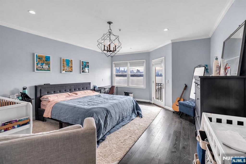314 The Promenade Edgewater, NJ 07020 - Photo 17 of 37 a spacious bedroom with a bed and a flat screen tv