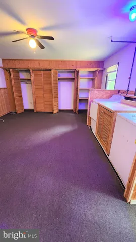 a bathroom with a granite countertop bathtub and a toilet