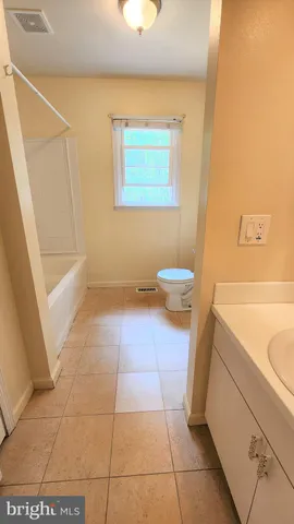 a view of a bathroom with wooden floor and a toilet