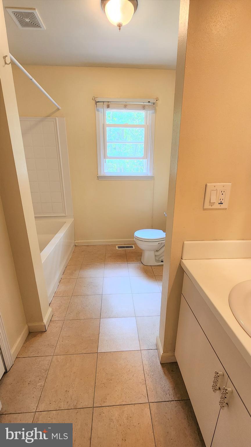 408 Deptford Road Glassboro, NJ 08028 - Photo 12 of 13 a bathroom with a granite countertop bathtub and a toilet