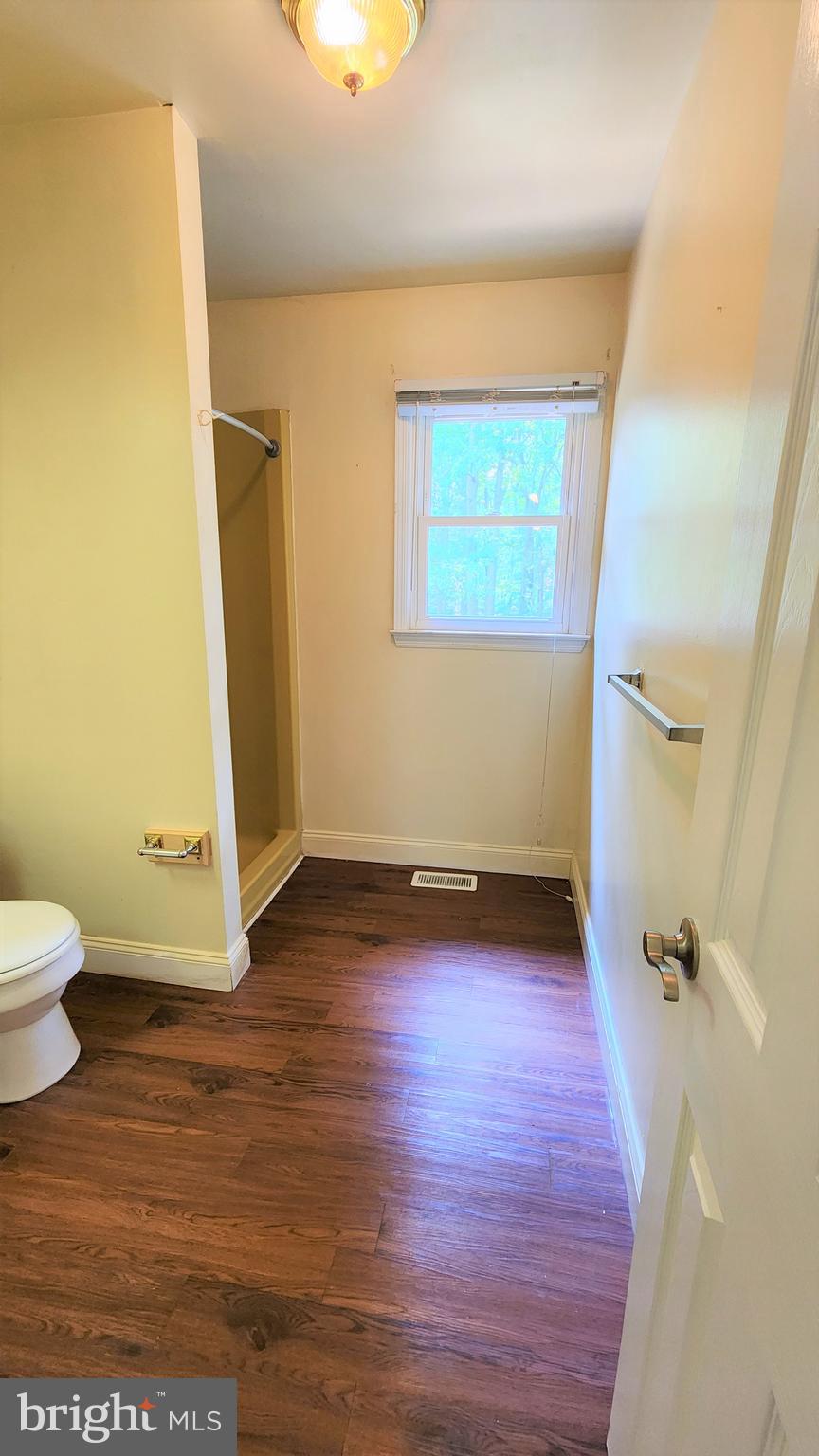 408 Deptford Road Glassboro, NJ 08028 - Photo 13 of 13 a view of a bathroom with wooden floor and a toilet